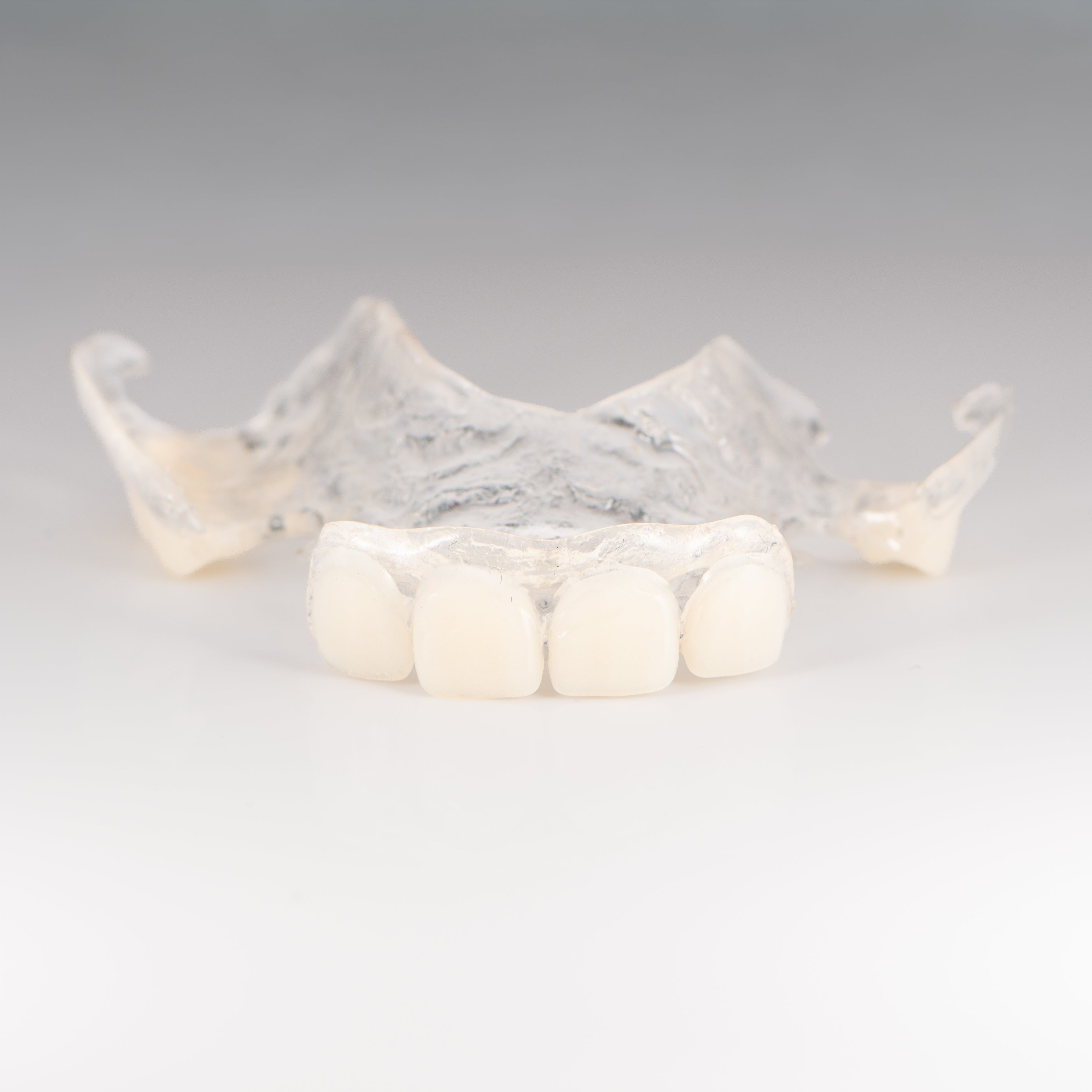 Clear Flexible Partial Denture on Gray Background