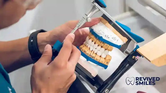 A Denture Technician checking the bite of an upper and lower full denture using an articulator