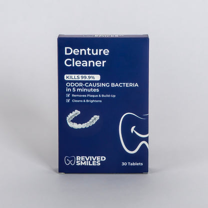 Box of Denture Cleaner by Revived Smiles on a gray background