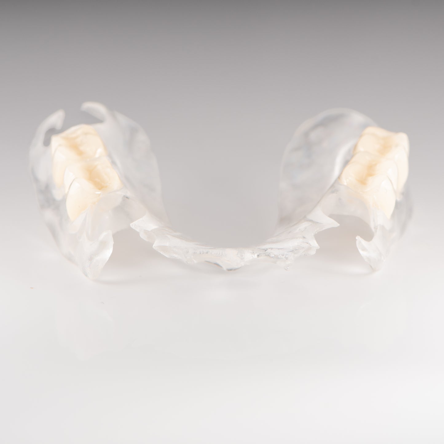 Clear Flexible Partial Denture on Gray Background