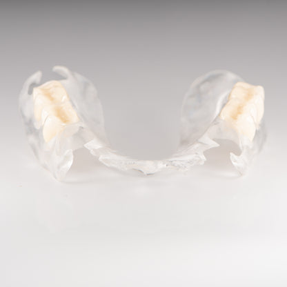 Clear Flexible Partial Denture on Gray Background
