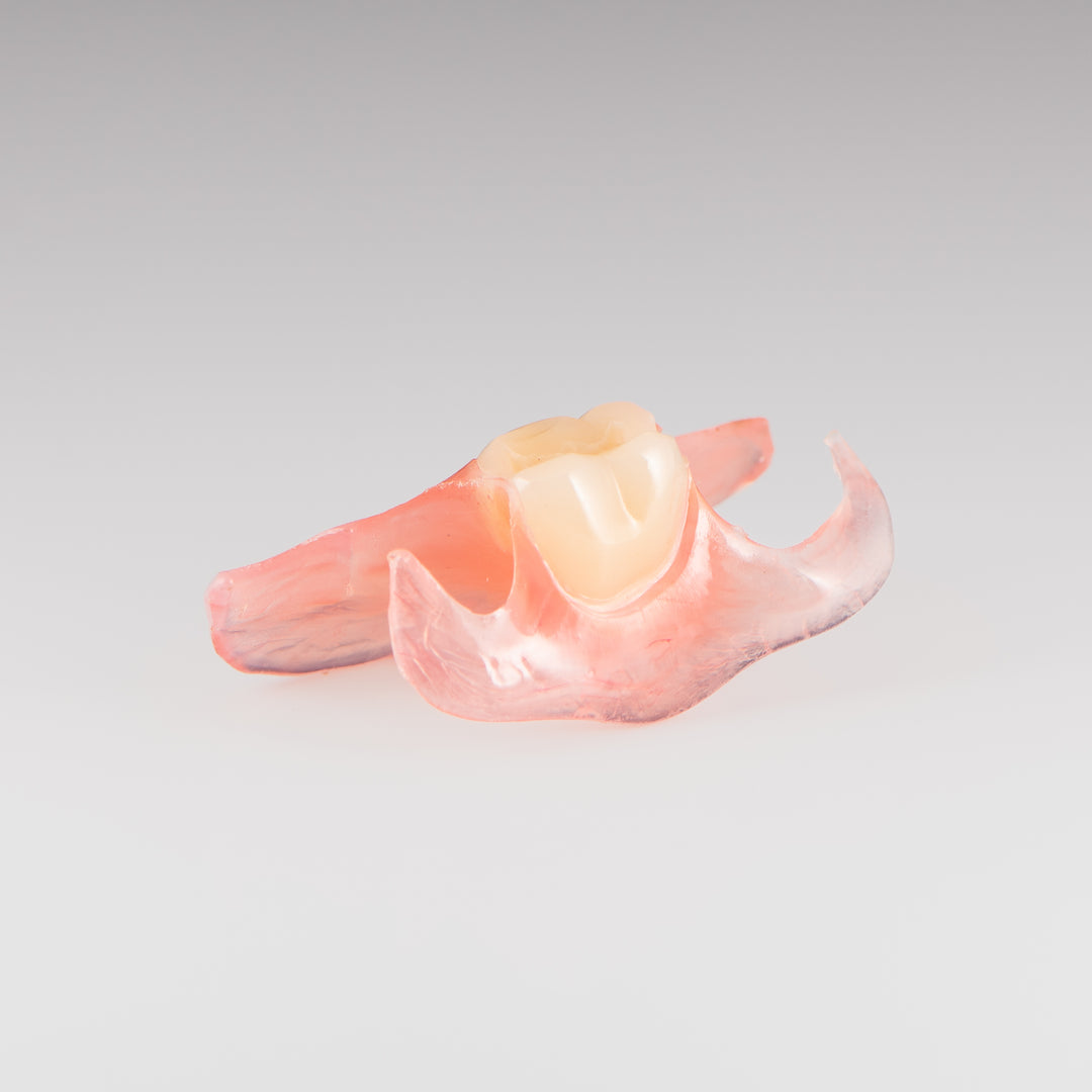 One-Tooth Unilateral Partial Denture on Gray Background