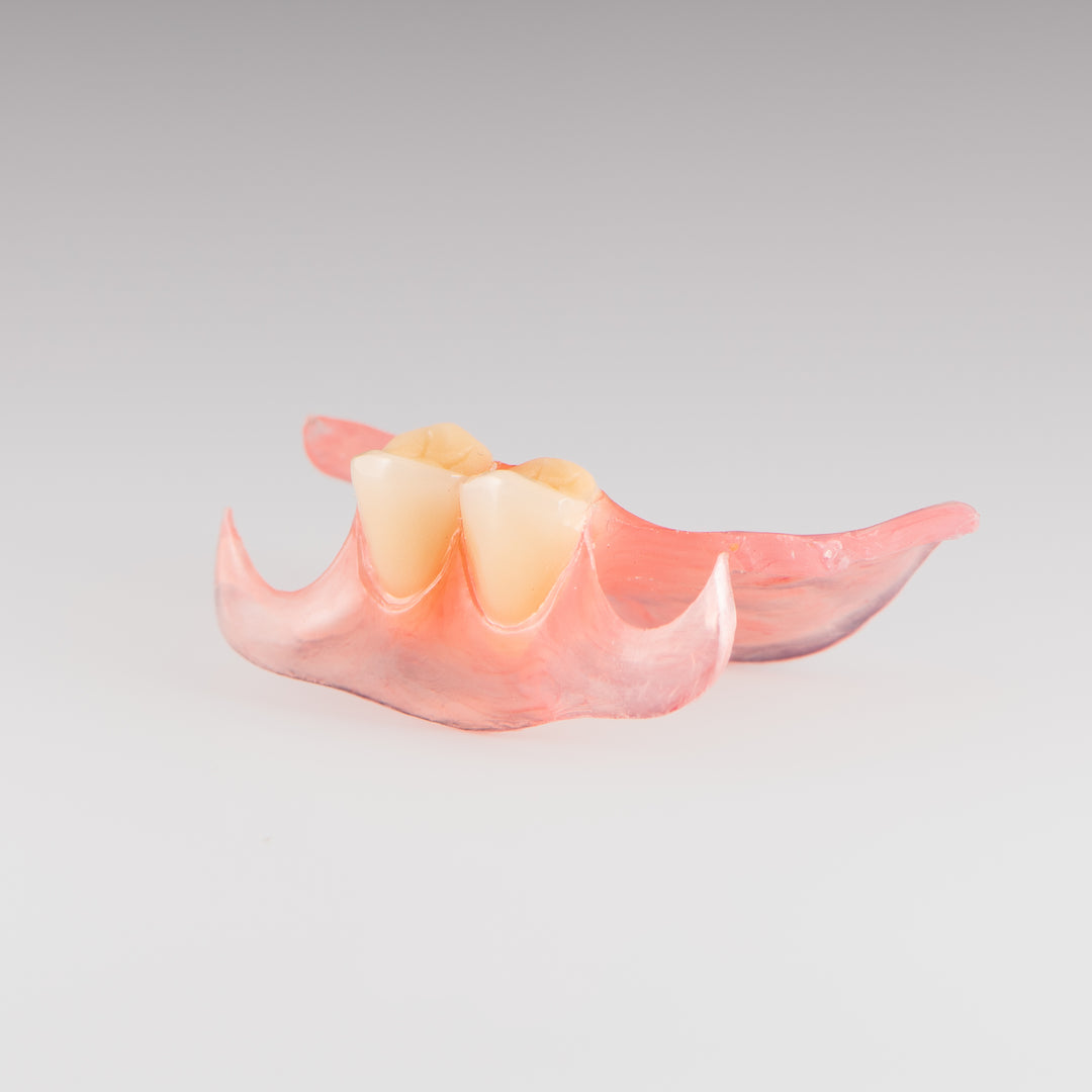 Two-Tooth Unilateral Partial Denture on Gray Background
