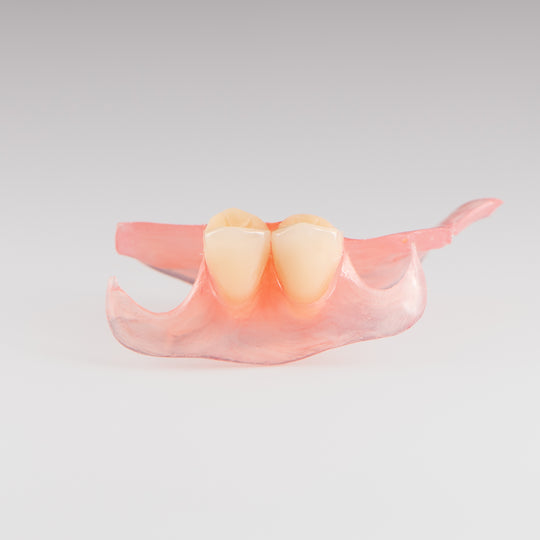 Two-Tooth Unilateral Partial Denture on Gray Background