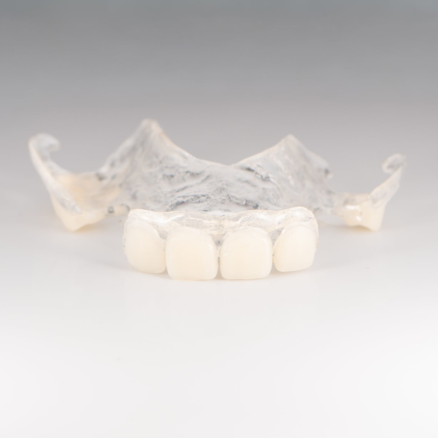 Clear Flexible Partial Denture on Gray Background
