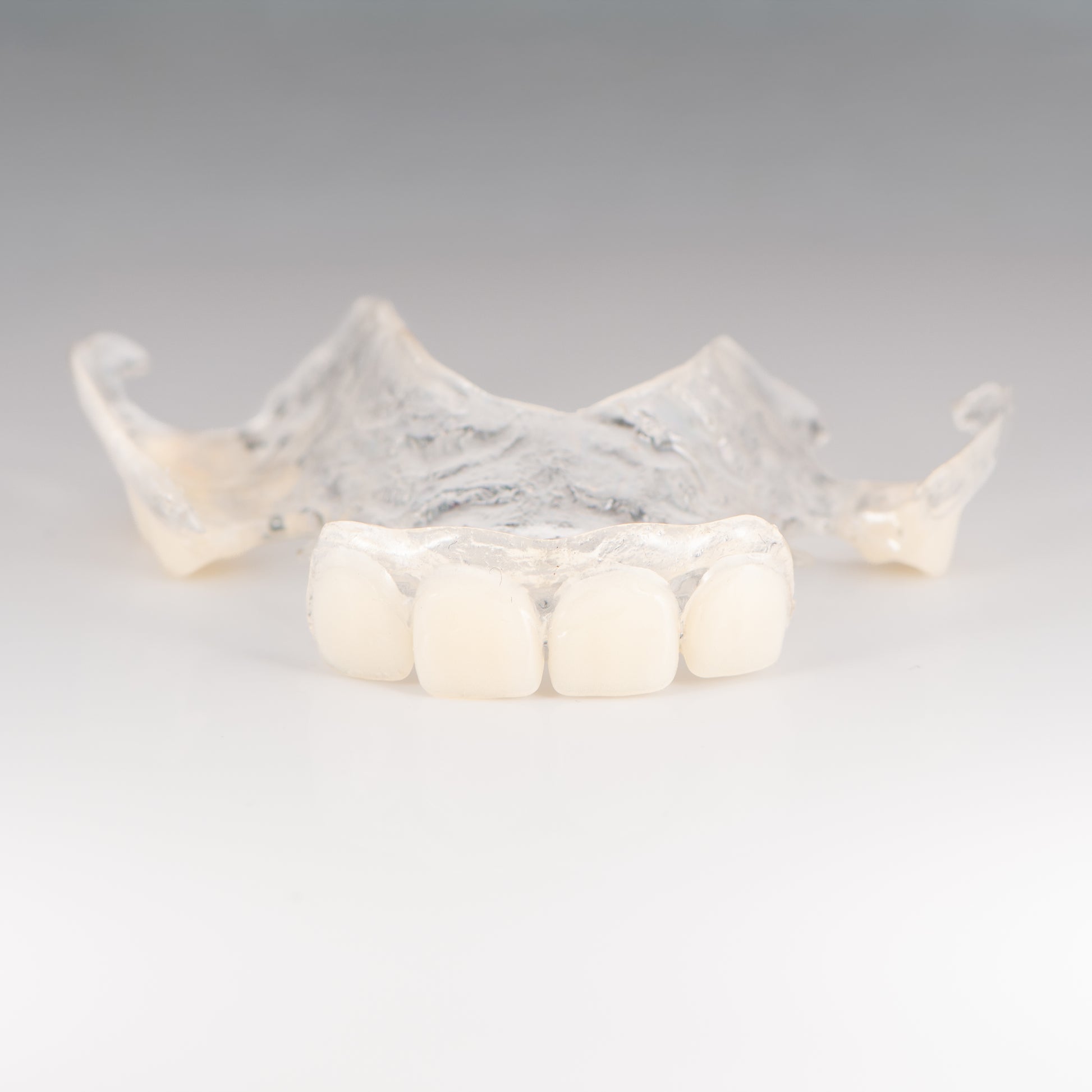 Clear Flexible Partial Denture on Gray Background