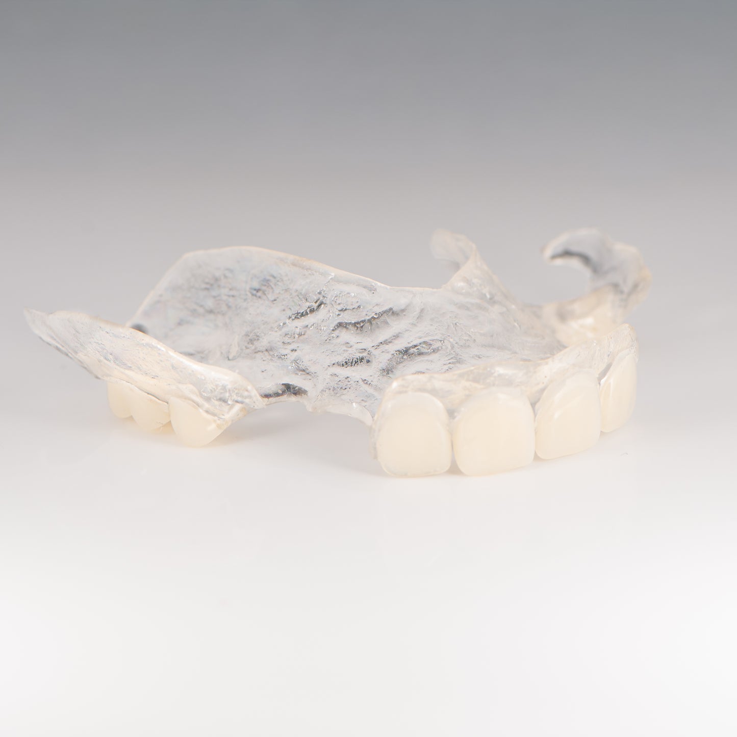 Clear Flexible Partial Denture on Gray Background