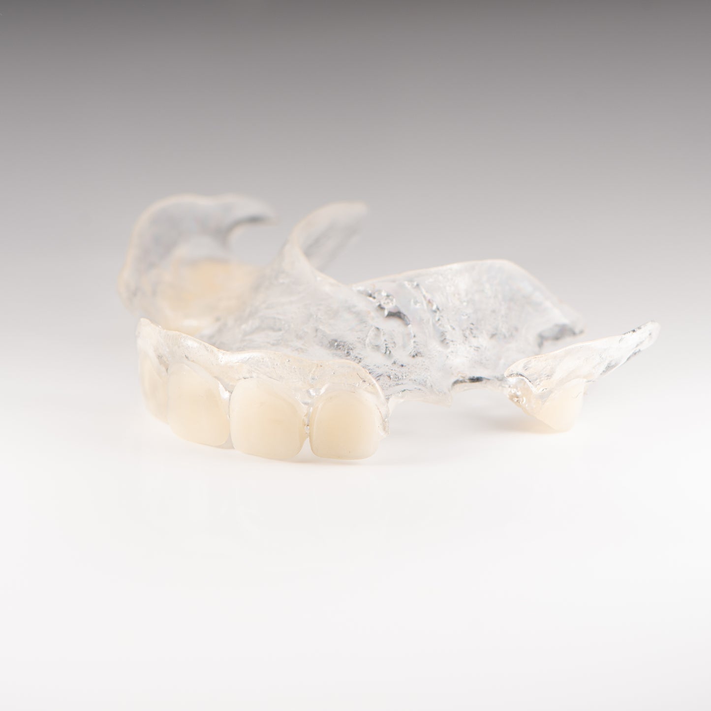 Clear Flexible Partial Denture on Gray Background