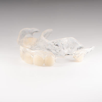 Clear Flexible Partial Denture on Gray Background