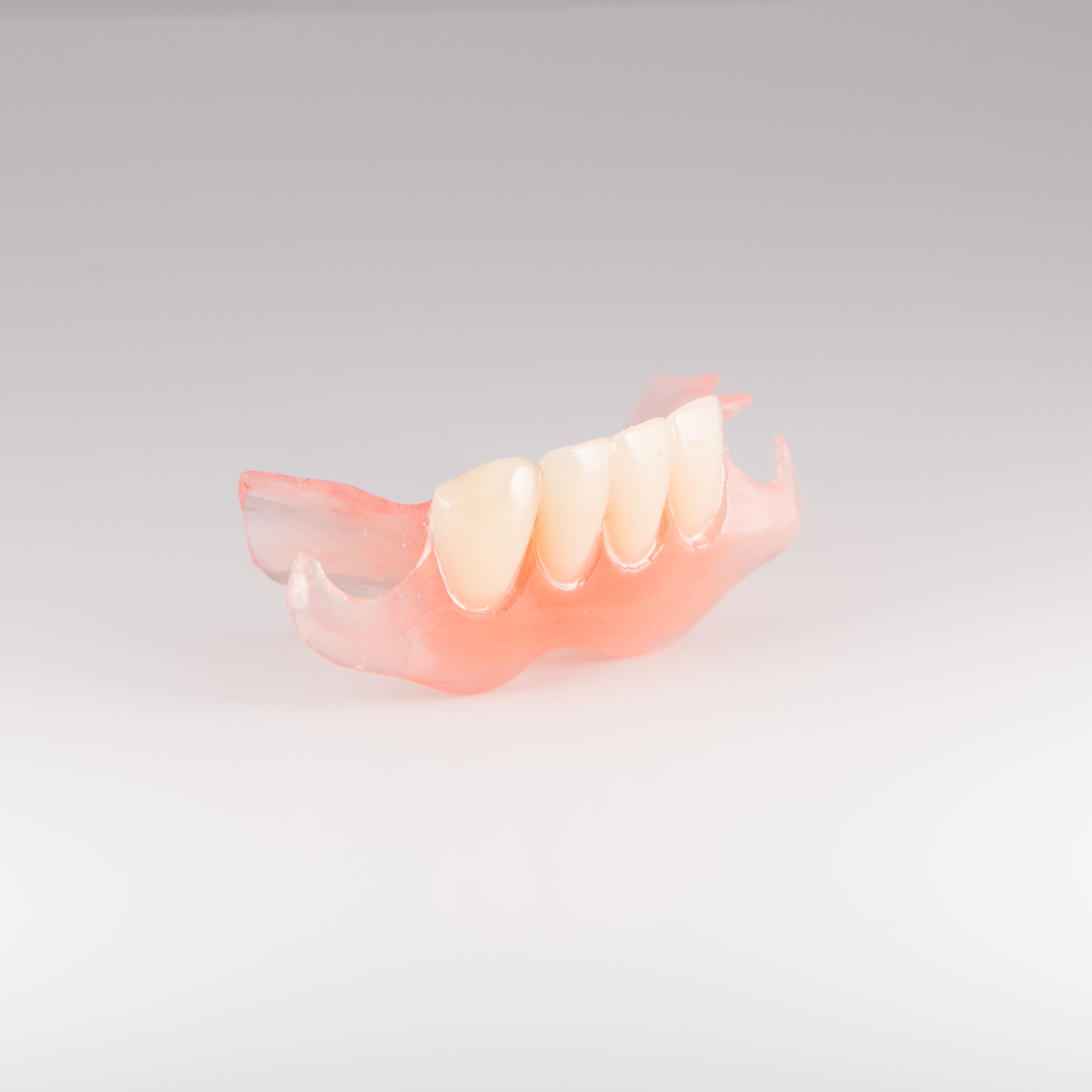 Lower Flexible Partial Denture on Gray Background