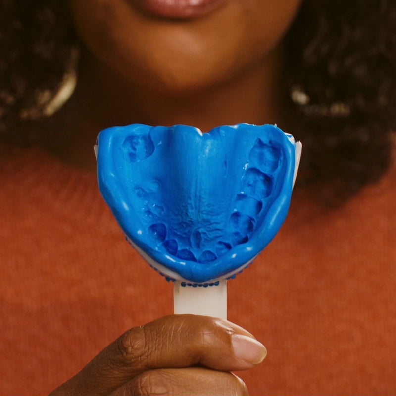 Person taking a dental impression at home